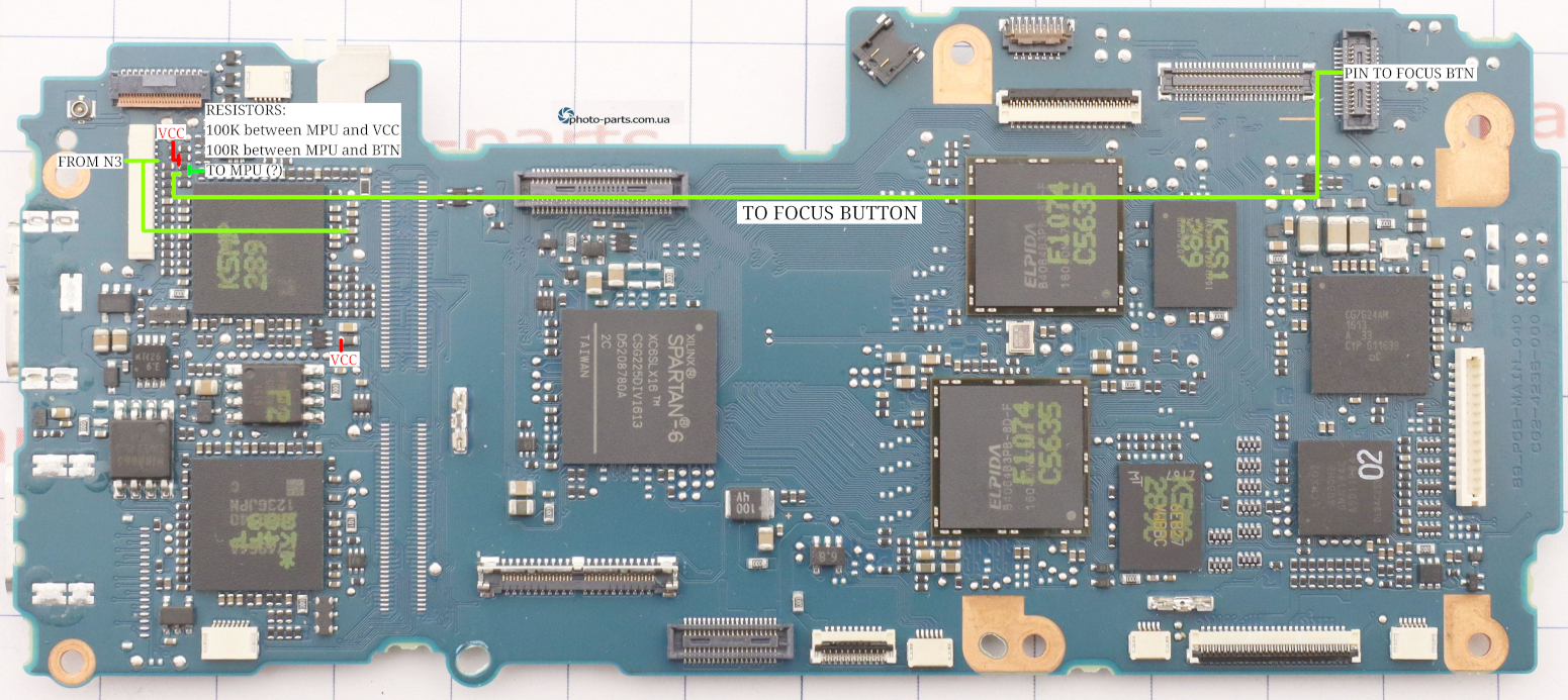 Top section, on it's back. Shutter button is on the top left.