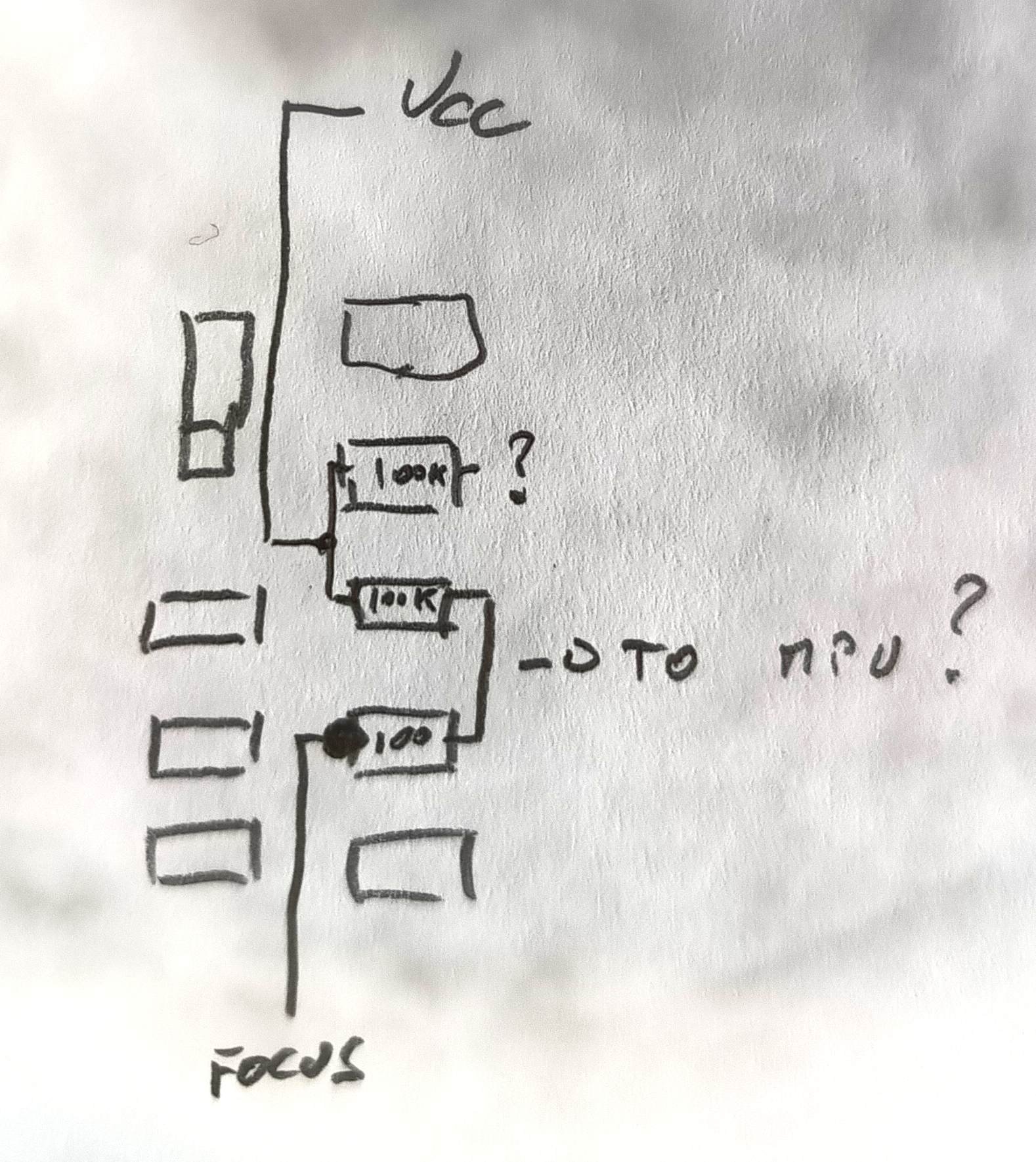 Top section, on it's back. Shutter button is on the top left.